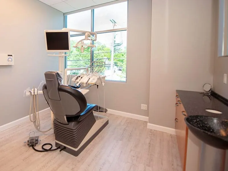 A treatment room at the practice, with a chair-side monitor and a window.
